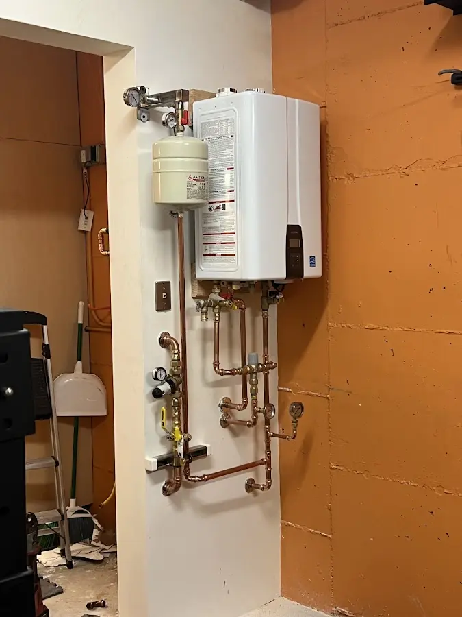 Plumbing technician inspecting water heater connections in Montgomery